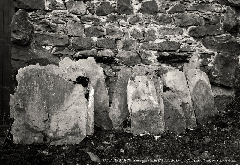Contrasting rocks and wall - black and white image