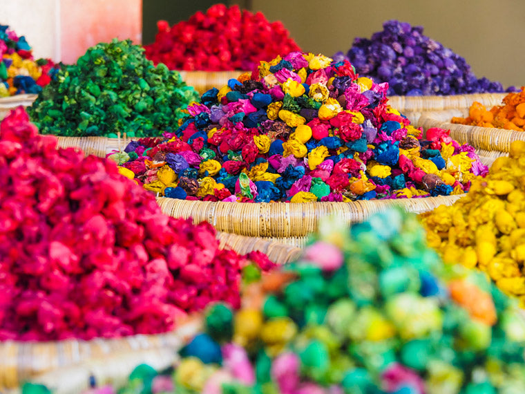 Brightly coloured flowers in baskets